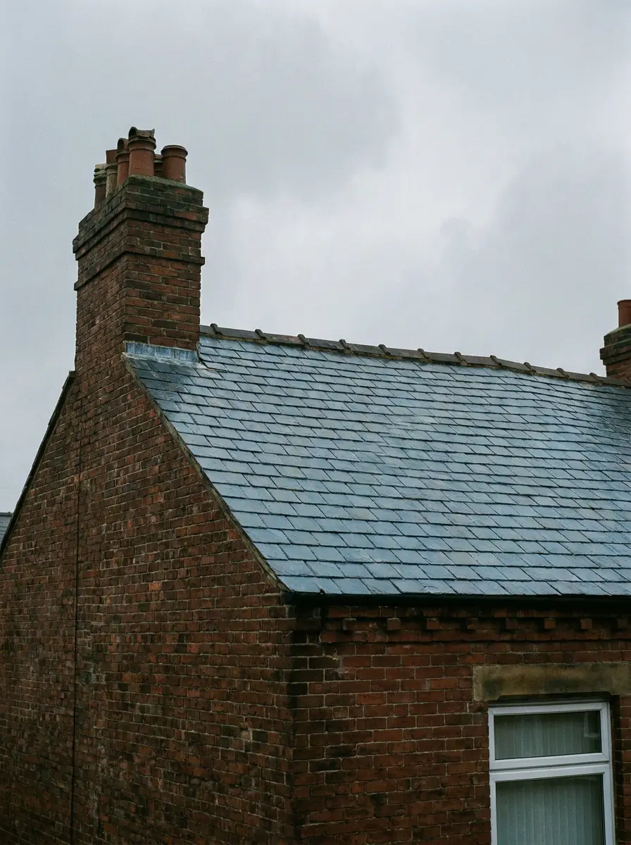 A finished natural slate roof on a Victorian brick terraced house